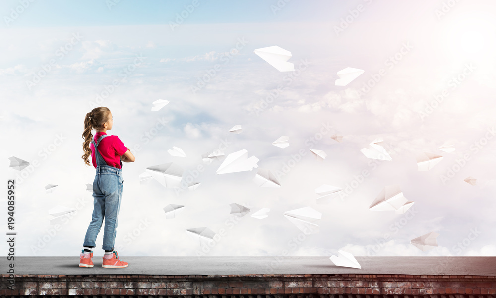 Concept of careless happy childhood with girl looking far away Concept of careless happy childhood with girl looking far away