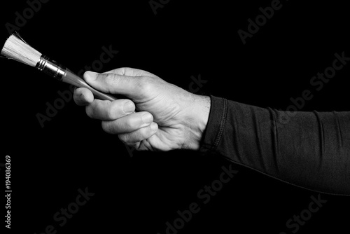 paintbrush - tools in a man's hand - black and white photo