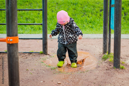 the child goes through the puddles photo