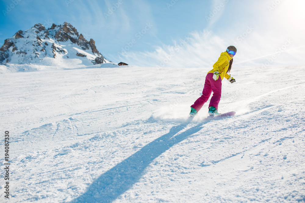Image of sports woman snowboarding on snowy slope