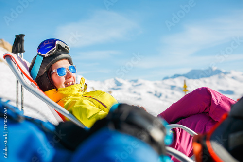 Photo Image of smiling sports woman lying on winter deckchair