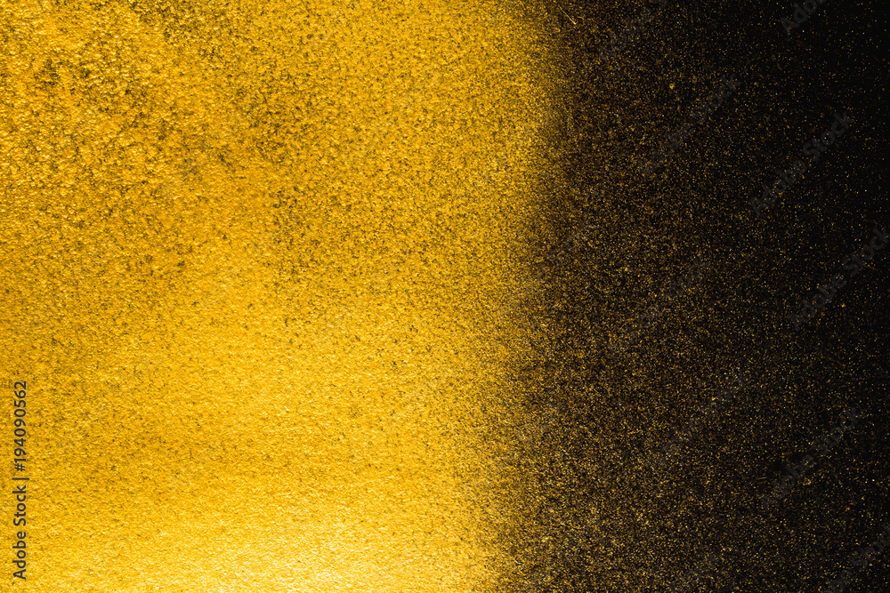 Golden abstract grainy texture on black background Golden abstract grainy texture on black background