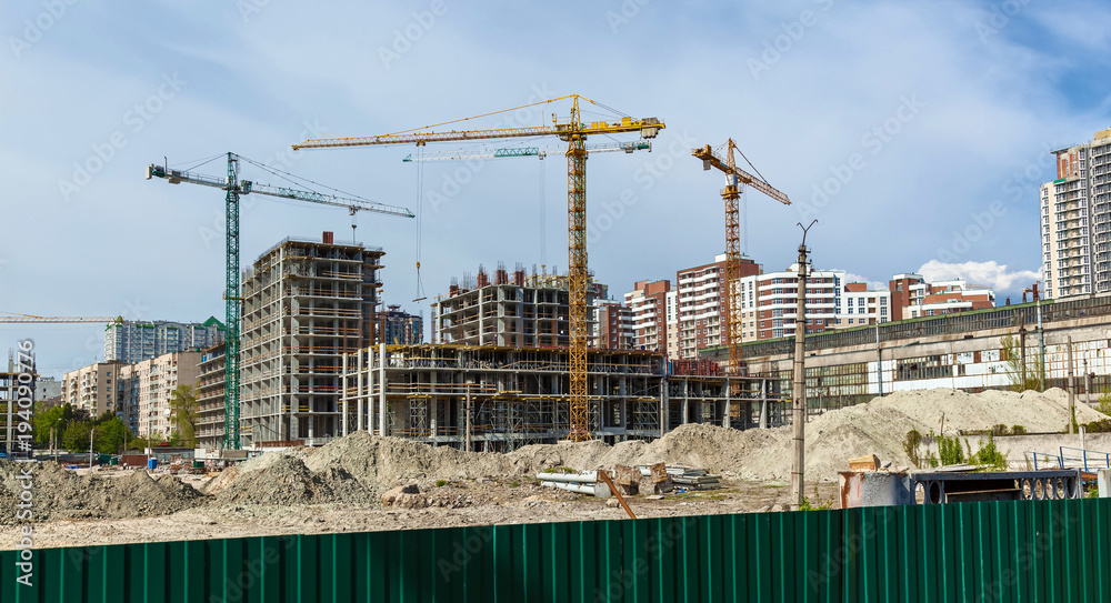 Site buildings under construction and cranes