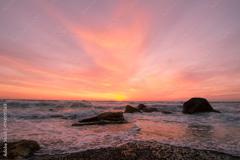 Fototapeta premium beautiful sea landscape in sunrise time, colorful pink and orange sky and storm in the sea.
