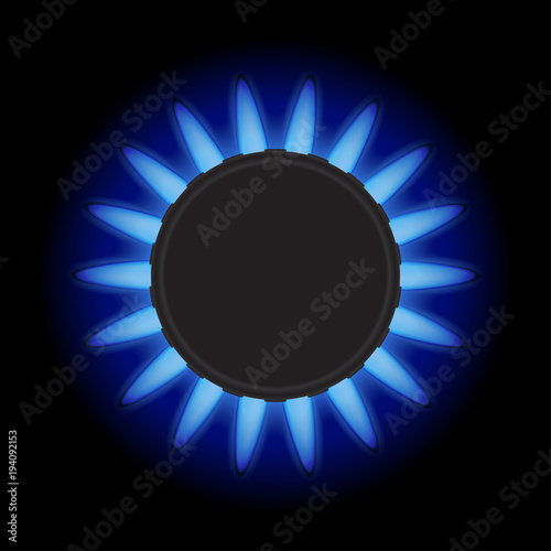 Burning blue flame gas burner on a black background. Top view.