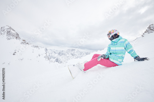 Young sitting woman with snowboard