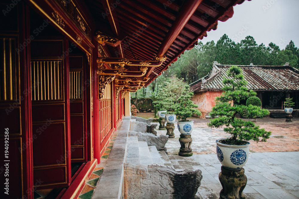 traditional oriental architecture and decorative bonsai trees in pots, Hue, Vietnam traditional oriental architecture and decorative bonsai trees in pots, Hue, Vietnam