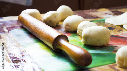 Bread dough with wooden rolling pin, homemade bakery equipment photo