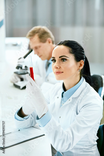 Scientists In Laboratory. Medical Workers At Work
