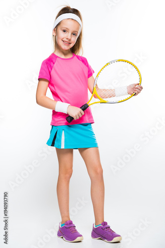Cute little girl with tennis racket in her hands on white background © Ivan Traimak
