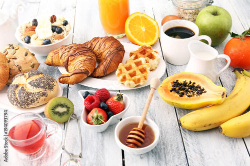 Breakfast served with coffee, orange juice, croissants and fruits. Balanced diet.