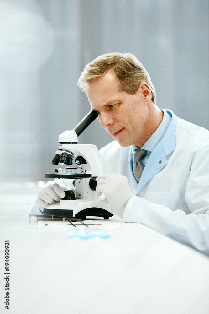 Clinical Test. Scientist With Microscope In Laboratory. Clinical Test. Scientist With Microscope In Laboratory.