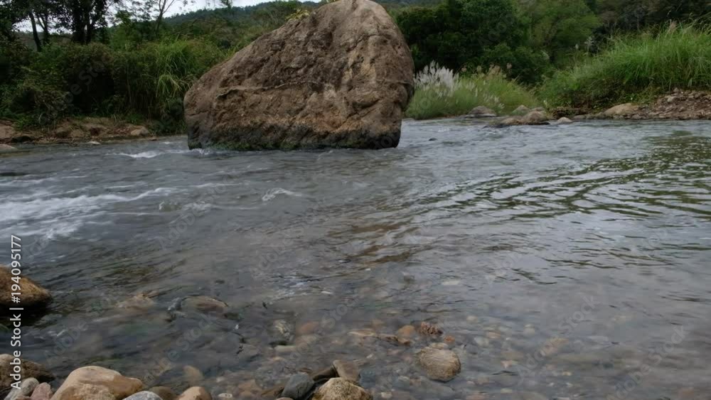 Pure fresh Stream flow in forest with black rocks and green jungle. Pure fresh Stream flow in forest with black rocks and green jungle.