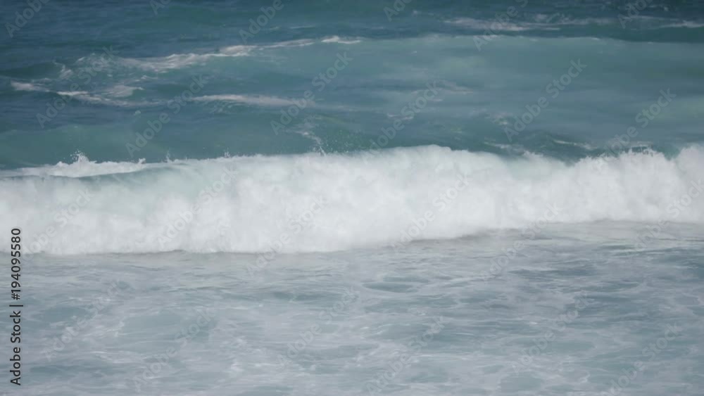 Roling waves fall against the rocks at Bondi Beach, in slow motion Roling waves fall against the rocks at Bondi Beach, in slow motion