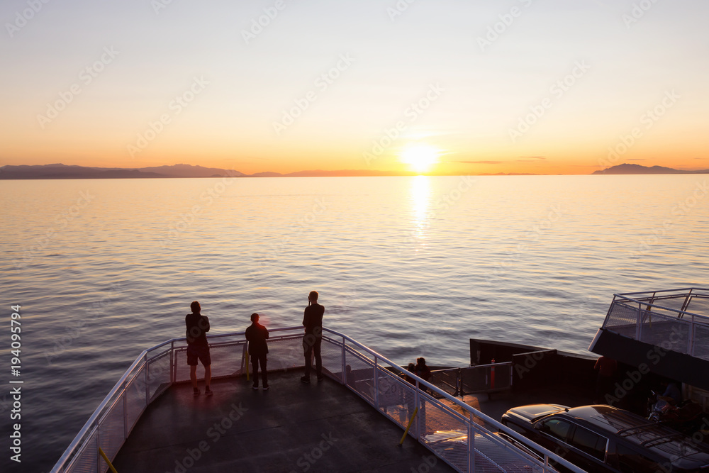 People on the ferry traveling from Vancouver to Vancouver Island, BC, Canada, are enjoying the beautiful summer sunset.