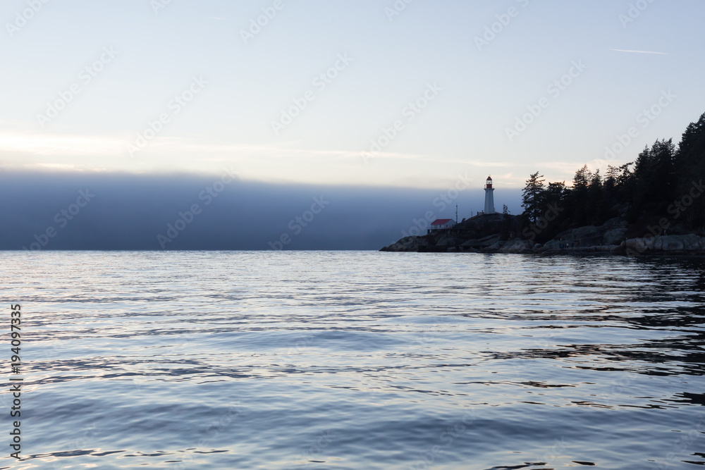 View of the Lighthouse Park during a fog covered sunset. Taken in Horseshoe Bay, West Vancouver, British Columbia, Canada.