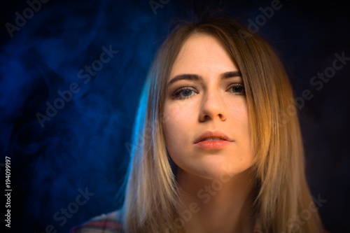 portrait smiling girl on blue background in studio