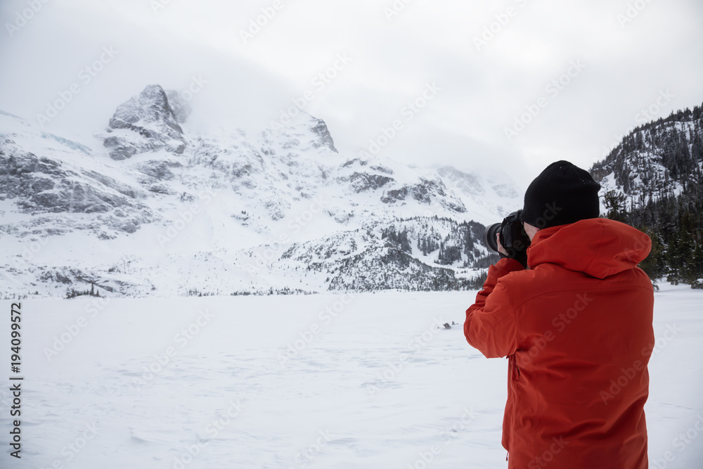 Photographer taking picture at Joffre Lakes, BC, Canada.