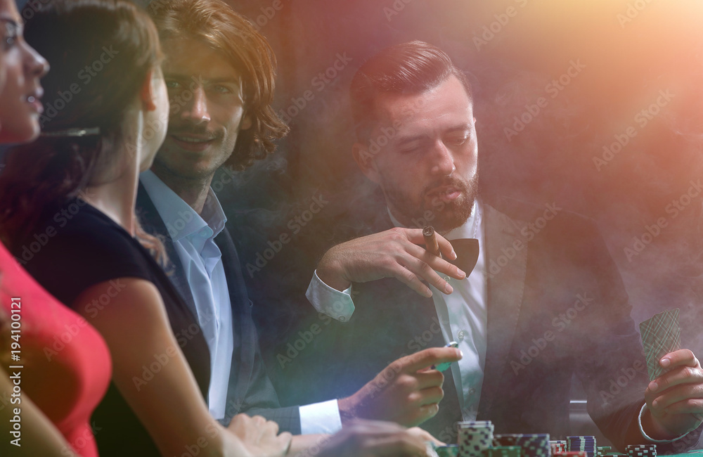 Upper class friends gambling in a casino Upper class friends gambling in a casino