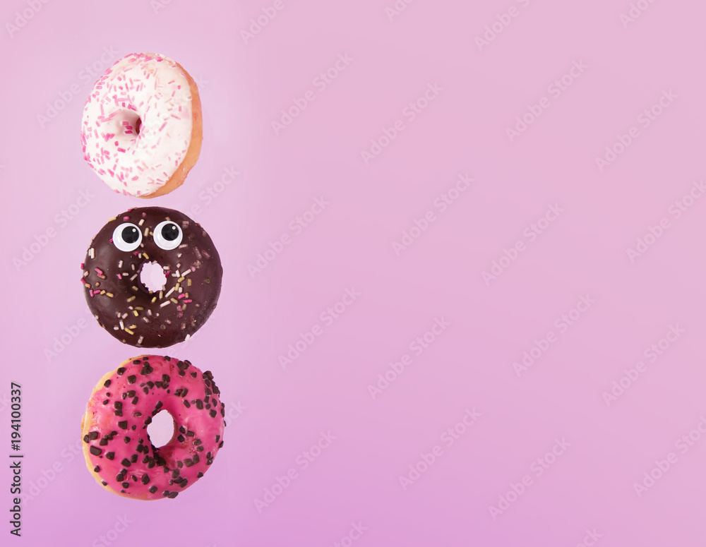 Colorful glazed donuts in motion with funny eyes. Colorful glazed donuts in motion with funny eyes.
