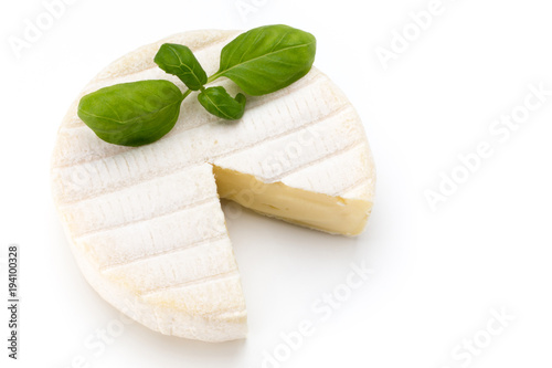 Piece of camembert cheese isolated on white background. From top view.