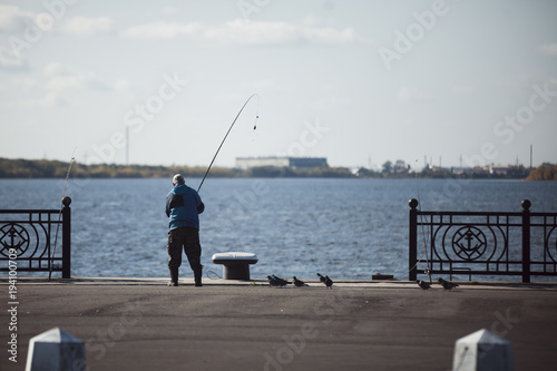 Fisherman on the city embankment