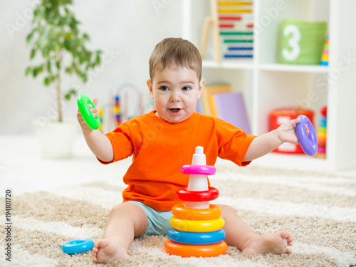 Funny baby boy playing with...