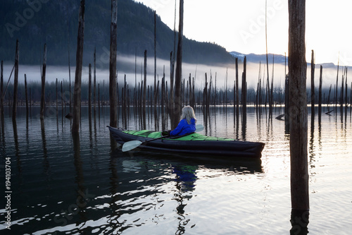 Adventurous woman kayaking during a beautiful morning. Taken in Stave Lake, East of Vancouver, British Columbia, Canada. Concept: Adventure, Travel, Holiday   © edb3_16