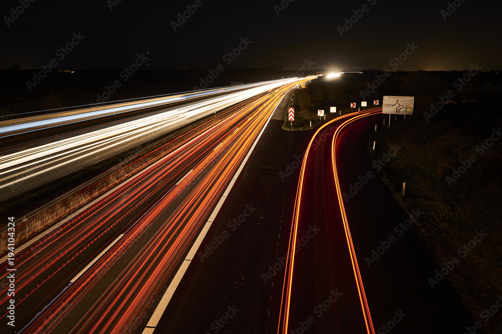 highway by night and with cars and traffic in motion