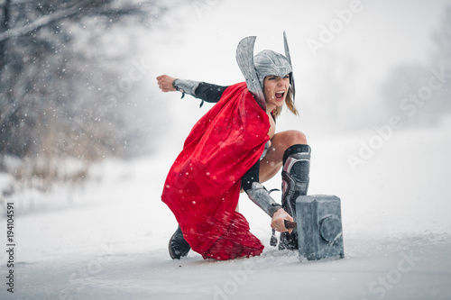 Furious woman in image of Germanic-Scandinavian God of thunder and storm. Cosplay. photo