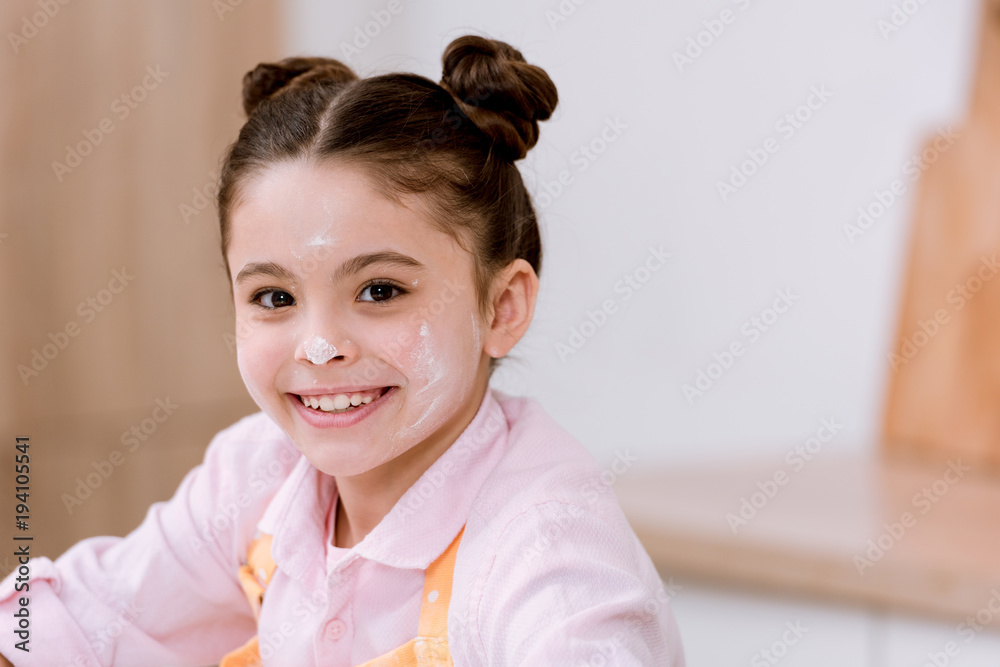 close-up portrait of little child with flour on face looking at camera close-up portrait of little child with flour on face looking at camera