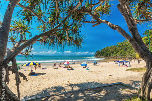 NOOSA, AUSTRALIA, FEB 17 2018: People enjoying summer at Noosa main beach - a famous tourist destination in Australia. photo