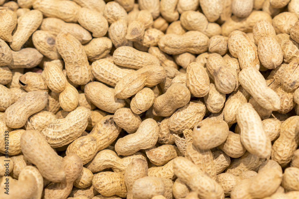 Many peanuts in shells, one upon the other. background Many peanuts in shells, one upon the other. background