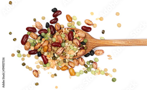 Mixed dried legumes and cereals with wooden spoon isolated on white background