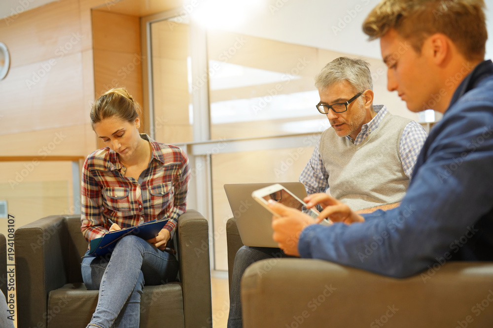 Group of students with teacher in lounge room Group of students with teacher in lounge room
