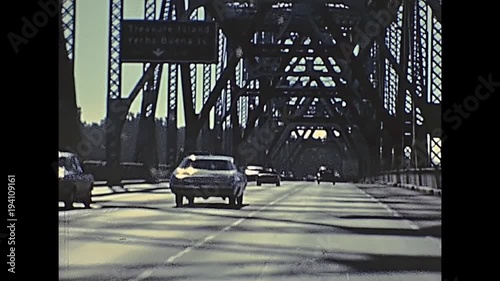 POV of vintage car crossing Oakland Bay Bridge passing by Treasure Island to Oakland. Archival footage in eighties. San Francisco, California, United States in 1980.