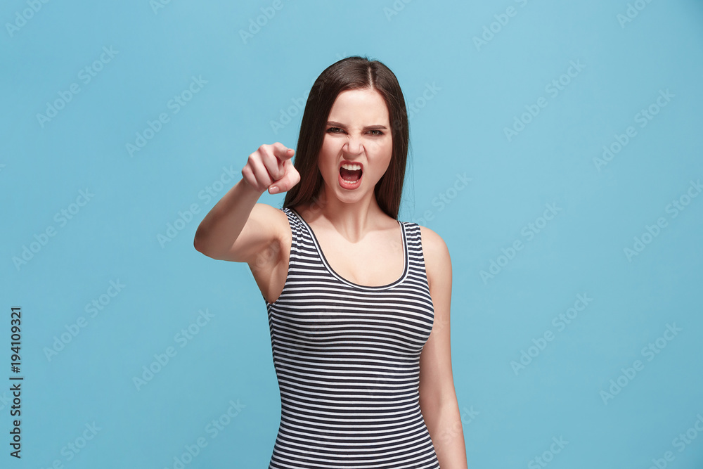 Fototapeta premium The overbearing woman point you and want you, half length closeup portrait on blue background.