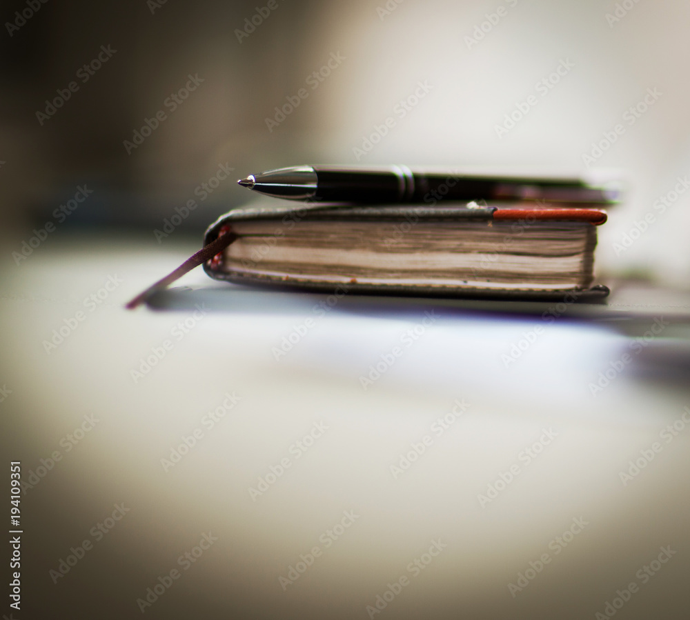 personal organizer and pen on office desk personal organizer and pen on office desk