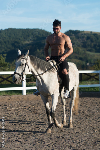 Handsome Man With Horse Riding