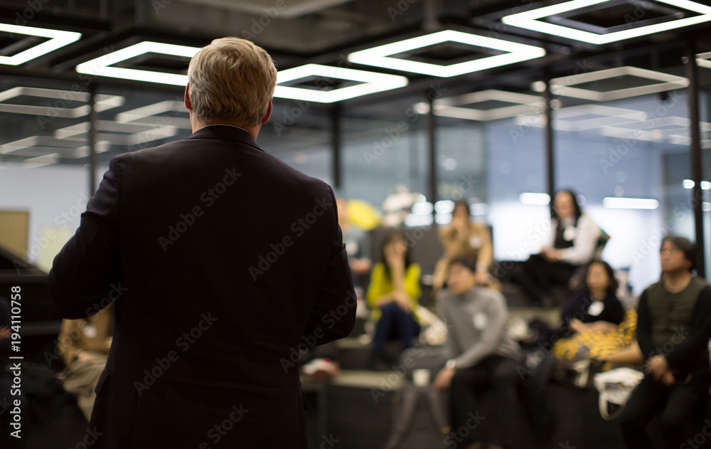 Business Professional Person Presenting to a Group of People. Discussion.