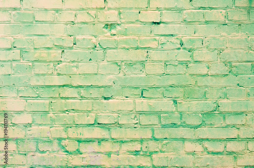 old yellow-green brick wall texture grunge background, may use to interior design. daylight.