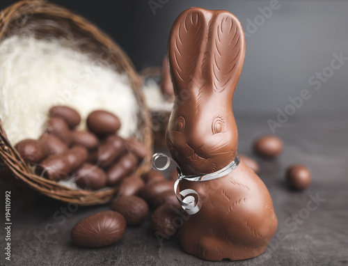 Chocolate Easter bunny and eggs on rustic background