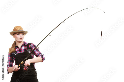 Focused woman in sun hat holding fishing rod