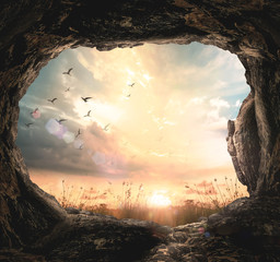 Empty tomb looking out at sunrise with birds flying, concept of resurrection, Jesus Christ victory and Easter Sunday