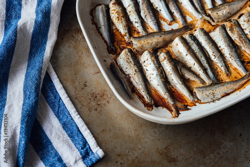Roasted baltic herring on white plate