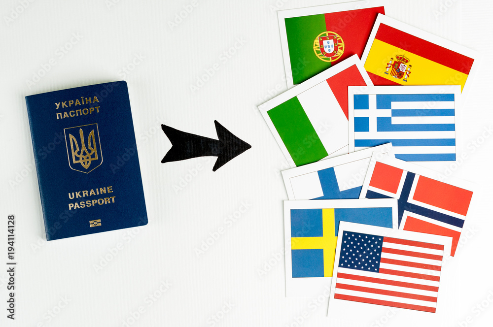 Blue Ukrainian passport  and several cards with prapors of the world. Says on a white background. Isolate.