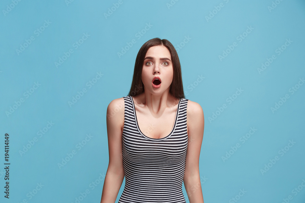 Beautiful woman looking suprised isolated on blue Beautiful woman looking suprised isolated on blue