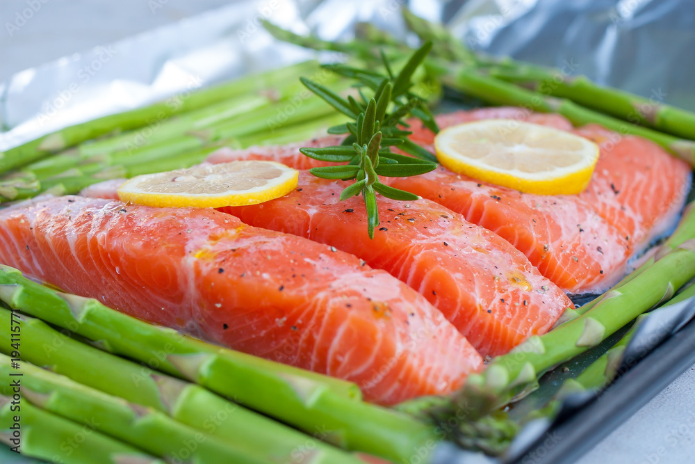 fresh salmon with asparagus and lemon in aluminium foil, ready for cooking