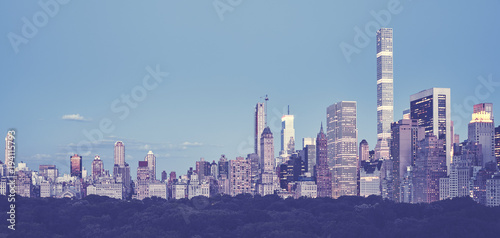 Vintage toned panoramic picture of the New York City skyline at dusk, USA.