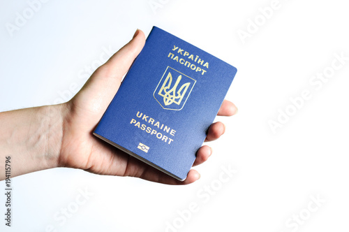 Blue Ukrainian passport in the a woman hands . Isolate